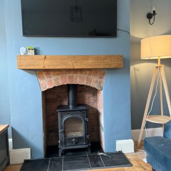 Knock out and restored natural brick fitted customers log burner that they sourced and we tiled with a black slate hearth : Click Here To View Larger Image
